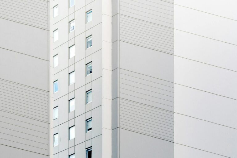 Contemporary building facade showcasing minimalist design with clean lines and glass windows.